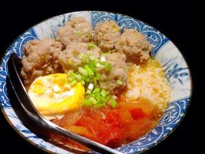 Close child the practice measure of rice served with meat and vegetables on top of tomato a round mass of food 9