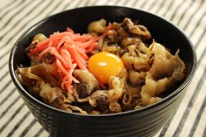 The practice measure of rice served with meat and vegetables on top of day type beef 10