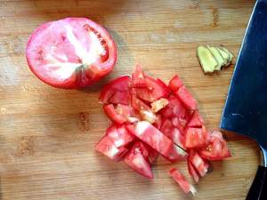 Close child the practice measure of rice served with meat and vegetables on top of tomato a round mass of food 3